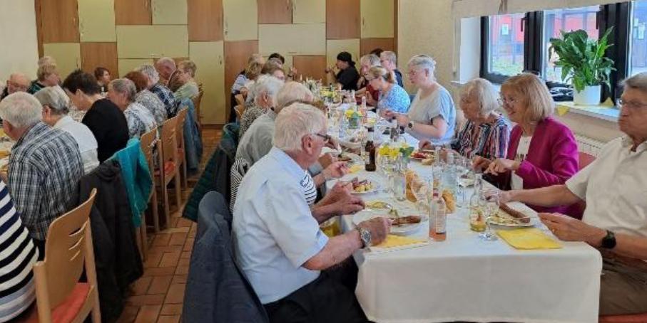 Fronleichnam 2026 - Fest der Begegnung im Jugendheim Merchweiler - Gäste an langen Tischen beim Essen (c) Simone Brennauer Fronleichnam 2026 - Fest der Begegnung im Jugendheim Merchweiler - Gäste an langen Tischen beim Essen
