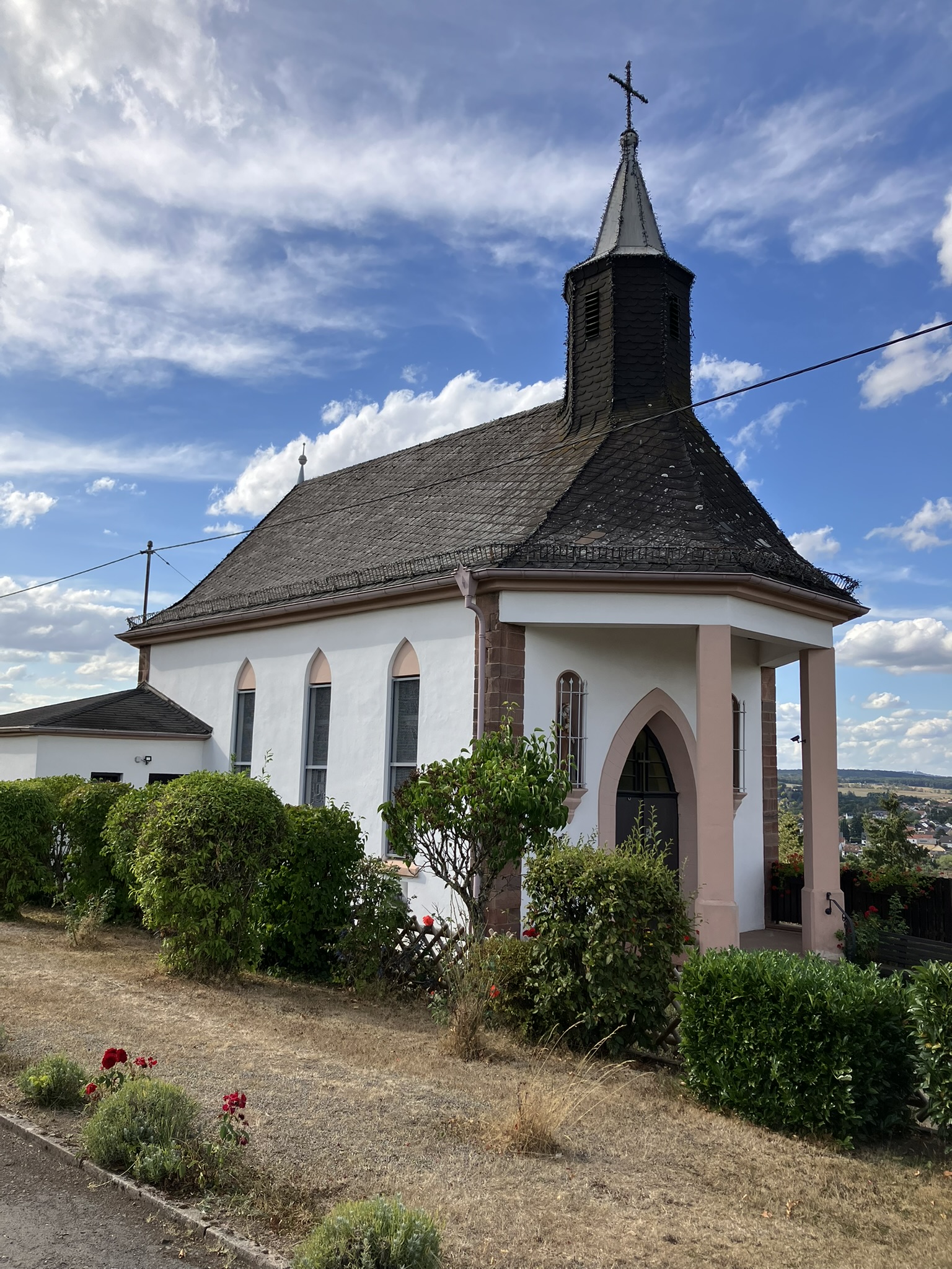 Kleinine weiße Kapelle, aufgenommen von vorne links, bei schönem Wetter..